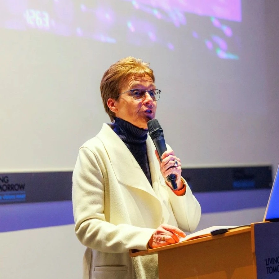 A speaker at a lectern presenting at a DPA event